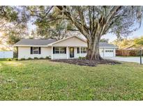 House with mature oak tree in front yard at 5105 Forestgreen W Dr, Lakeland, FL 33811