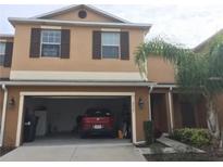 Two-story house with attached garage and landscaping at 3319 Rodrick Cir, Orlando, FL 32824