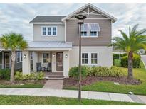 Two-story house with gray siding, metal roof at 8760 Shapley St, Orlando, FL 32827