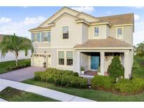 Two-story house with light beige siding, blue shutters, and a landscaped front yard at 9849 Lost Creek Dr, Winter Garden, FL 34787