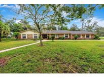 Brick ranch home with a large yard and walkway at 1215 Waverly Way, Longwood, FL 32750