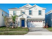 Two-story house with a blue door, white exterior, and a three-car garage at 1540 Maidstone Ct, Davenport, FL 33896