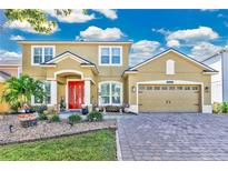 Two-story home with a two-car garage and attractive landscaping at 1562 Amaryllis Cir, Orlando, FL 32825