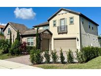 Two-story home with stone accents and a three-car garage at 16779 Broadwater Ave, Winter Garden, FL 34787