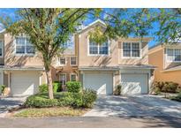Two-story townhome with attached garage and landscaping at 2847 Metro Sevilla Dr # 105, Orlando, FL 32835
