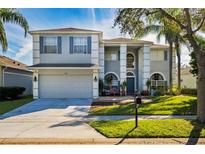 Two-story house with gray siding, gray shutters, and a two-car garage at 1349 Castleport Rd, Winter Garden, FL 34787