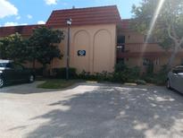 Exterior view of Oak Shadows Condominium building, showcasing its architecture and landscaping at 2850 N Powers Dr # 9, Orlando, FL 32818