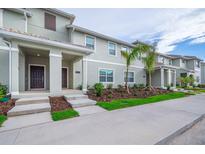 Modern townhome community with landscaped yards and spacious porches at 4819 Memories Ln, Kissimmee, FL 34746