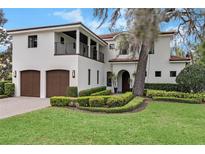 Beautiful two-story home with a lush green lawn at 2550 Venetian Way, Winter Park, FL 32789