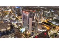 Nighttime aerial view of a modern highrise building with city lights at 155 S Court Ave # 2609, Orlando, FL 32801