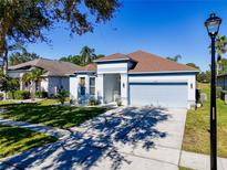 House exterior with two-car garage and landscaping at 2515 Runyon Circle, Orlando, FL 32837