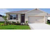 Single story home with neutral exterior, two car garage, and landscaping at 4185 Singing Mockingbird Blvd, Bartow, FL 33830
