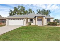 One-story house with attached garage, and a well-maintained lawn at 538 Lakeview Dr, Kissimmee, FL 34759