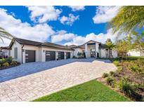 Luxury home with three-car garage and paver driveway at 15144 Pendio Dr, Montverde, FL 34756
