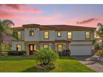 Two-story house with a red tile roof, stone accents, and a three-car garage at 19206 Robertson St, Orlando, FL 32833