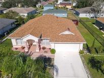 Aerial view of single-Gathering home with driveway and landscaped yard at 552 Eagle Ct, Poinciana, FL 34759