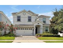 Two-story home with stone accents and a three-car garage at 1680 Moon Valley Dr, Davenport, FL 33896