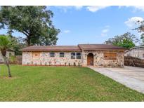 Ranch style home with stone facade and spacious yard at 6427 Sunshine St, Orlando, FL 32818