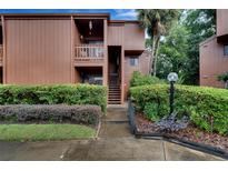 Condo building exterior with landscaping and walkway at 1038 E Michigan St # 1, Orlando, FL 32806