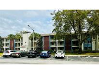 Exterior view of a condo building with parking and landscaping at 3 Escondido Cir # 18, Altamonte Springs, FL 32701