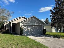 One-story house with a two-car garage and a well-maintained lawn at 3467 Arabesque Dr, Deland, FL 32724