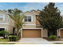 Two-story townhome with attached garage and landscaped front yard at 1537 Orrington Payne Place, Casselberry, FL 32707