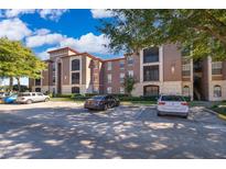 Exterior view of a residential building with parking at 6141 Metrowest Blvd # 102, Orlando, FL 32835