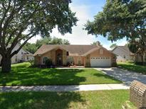 Single-story home with a two-car garage and well-maintained lawn at 6618 Abeydon Ct, Orlando, FL 32818
