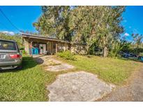 Ranch-style home with carport and mature trees at 801 N Clermont Ave, Fort Meade, FL 33841