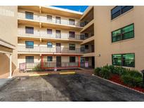 Exterior view of condo building with parking and ground floor entrance at 3807 S Atlantic Ave # 2020, Daytona Beach, FL 32118