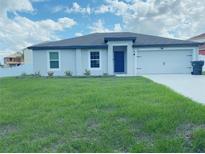 Newly constructed home with a well-manicured lawn and a two-car garage at 414 Rio Grande Ct, Kissimmee, FL 34759