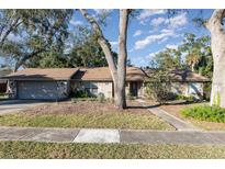 Single-story house with stone accents and a two-car garage at 141 Columbus Cir, Longwood, FL 32750