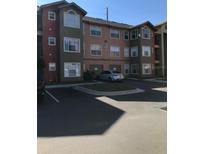 Exterior view of a three-story residential building with parking at 2202 Key West Ct # 632, Kissimmee, FL 34741