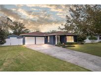 Ranch-style home with a two-car garage and nicely landscaped yard at 423 N Main St, Winter Garden, FL 34787