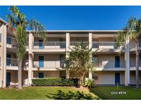 Two-story condo building with balconies and lush landscaping at 7270 Westpointe Blvd # 914, Orlando, FL 32835