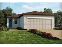 One-story home with a two-car garage and landscaped front yard at 3197 Viceroy Ct, Poinciana, FL 34759