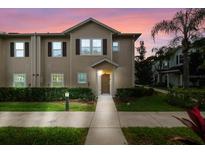 Two-story townhome with neutral siding and landscaping at 3214 Gold Ln, Kissimmee, FL 34747