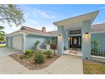 Inviting home exterior with a covered entryway and well-maintained landscaping at 5016 Dorman Rd, Lakeland, FL 33813