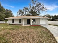 Newly constructed home with a covered porch and attached garage at 5350 Se 102Nd Pl, Belleview, FL 34420