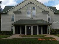 Condo building exterior, featuring three units and a walkway at 6106 Westgate Dr # 102, Orlando, FL 32835