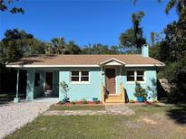 Newly renovated light blue home with a landscaped front yard and a wooden walkway at 810 Rosalia Dr, Sanford, FL 32771