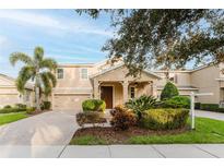 Two-story house with a double-car garage and well-manicured landscaping at 8121 Atlantic Puffin St, Winter Garden, FL 34787