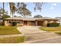 Ranch style home with a large driveway and mature landscaping at 172 Sheridan Ave, Longwood, FL 32750