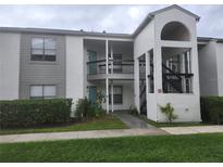 Well-maintained condo building with landscaping and a walkway at 2260 Cascades Blvd # 107, Kissimmee, FL 34741