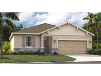 One-story home with light beige siding, stone accents, and a two-car garage at 1708 Columbus Path, St Cloud, FL 34771