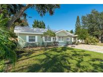 Charming light green house with a well-manicured lawn at 1333 Orchid Ave, Winter Park, FL 32789