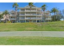 Multi-story condo building with balconies and lush landscaping at 1370 Centre Court Ridge Dr # 304, Kissimmee, FL 34747