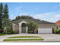 Brick house with a 3-car garage and paved driveway at 349 Plantation Club Dr, Debary, FL 32713