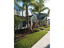 Attractive townhouses with lush landscaping and a convenient sidewalk at 9004 Shine Dr, Kissimmee, FL 34747