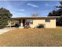 Ranch-style home with carport and mature landscaping at 1403 Amaros Ave, Orlando, FL 32811